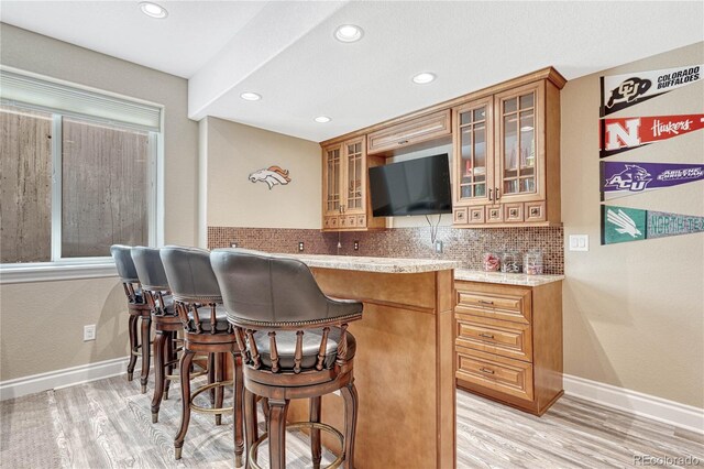 9121 Sunshine Meadow Pl, Parker, CO 80134 - indoor wet bar featuring decorative backsplash, light wood-style floors, recessed lighting, and baseboards