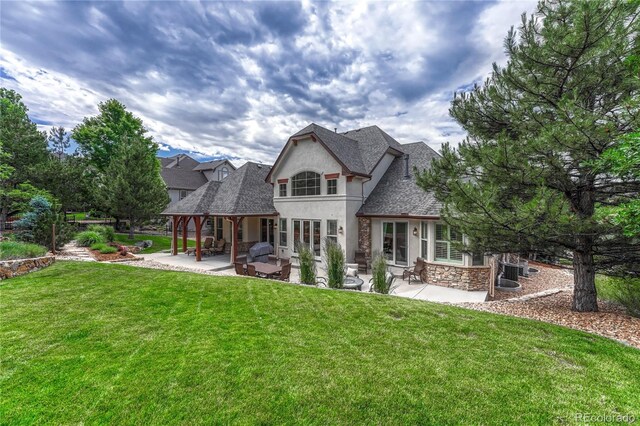 9121 Sunshine Meadow Pl, Parker, CO 80134 - back of house featuring stucco siding, a patio area, stone siding, and a lawn