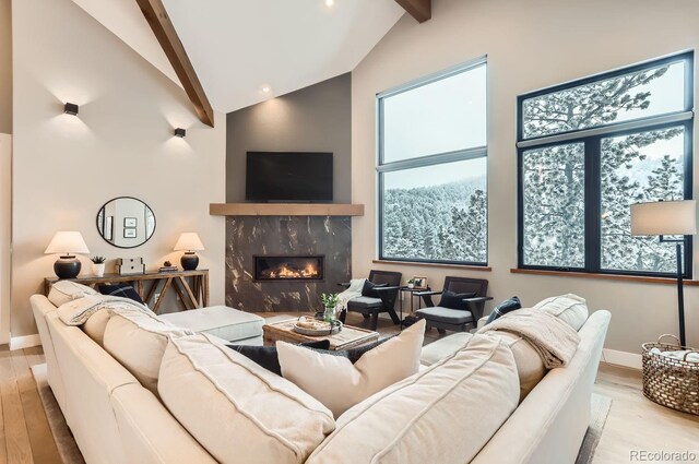 795 Pine Brook Rd, Boulder, CO 80304 - living room with beam ceiling, wood finished floors, high vaulted ceiling, a premium fireplace, and baseboards