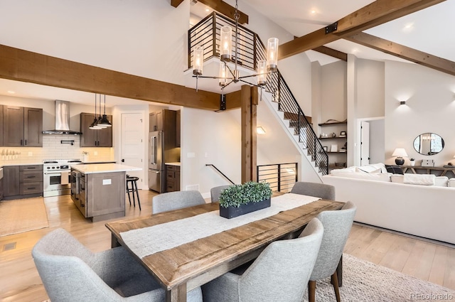 795 Pine Brook Rd, Boulder, CO 80304 - dining area featuring high vaulted ceiling, beamed ceiling, light wood finished floors, stairway, and a chandelier