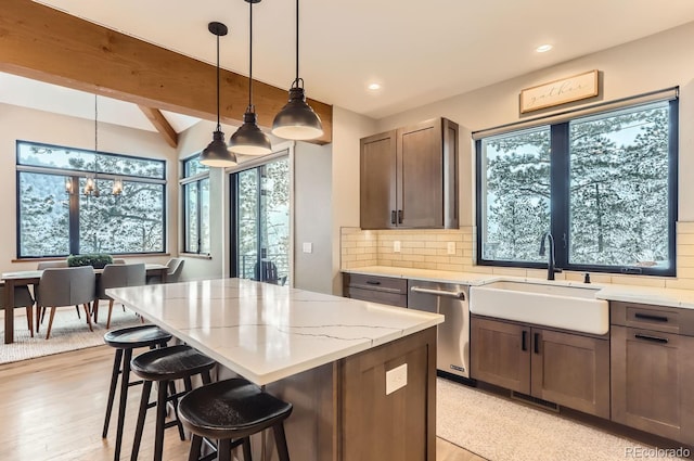 795 Pine Brook Rd, Boulder, CO 80304 - kitchen featuring a sink, stainless steel dishwasher, tasteful backsplash, a kitchen island, and light stone countertops