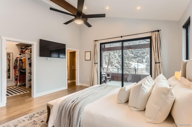 795 Pine Brook Rd, Boulder, CO 80304 - bedroom with a spacious closet, high vaulted ceiling, wood finished floors, baseboards, and access to exterior