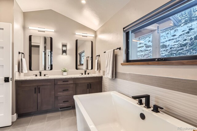 795 Pine Brook Rd, Boulder, CO 80304 - full bath with vaulted ceiling, a freestanding bath, double vanity, and tile patterned flooring