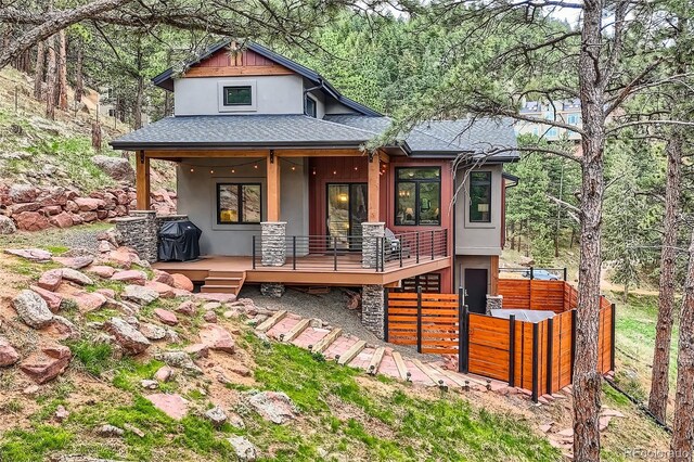 795 Pine Brook Rd, Boulder, CO 80304 - view of front facade with a shingled roof, stucco siding, covered porch, and stone siding