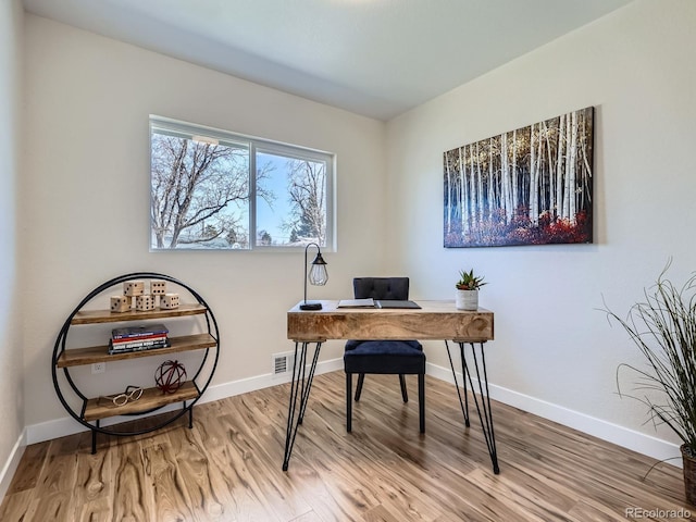 office featuring visible vents, baseboards, and wood finished floors