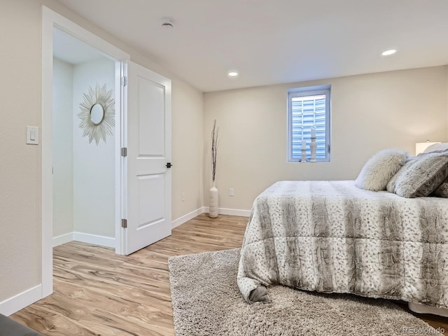 bedroom with recessed lighting, baseboards, and light wood finished floors