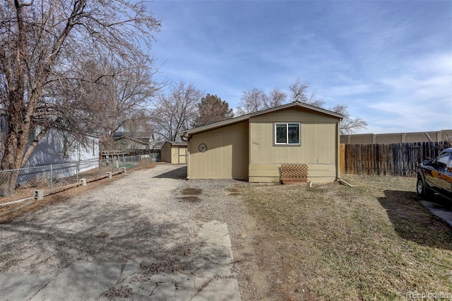 view of outbuilding featuring an outbuilding and fence