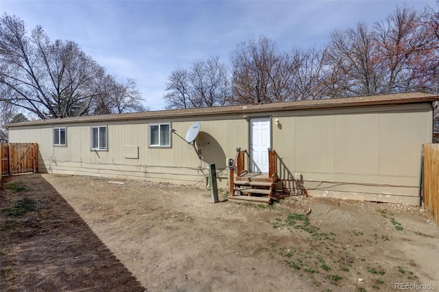 rear view of house with fence