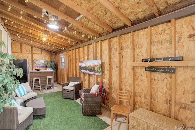 living area featuring carpet floors and vaulted ceiling