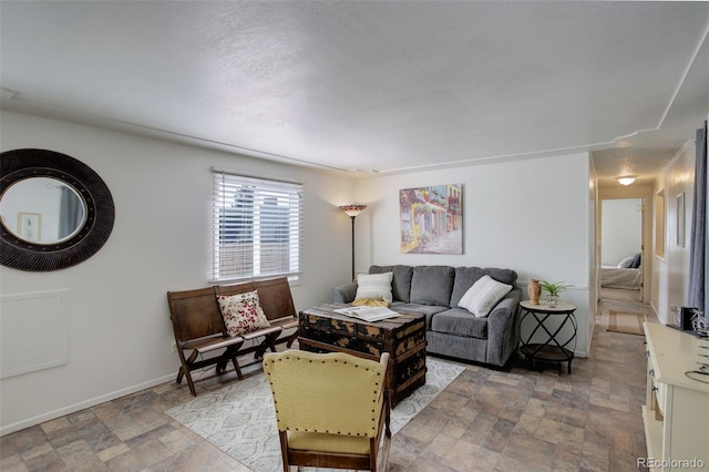 living room featuring stone finish flooring and baseboards