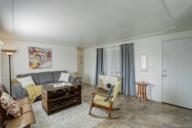 living area with stone finish floor and baseboards