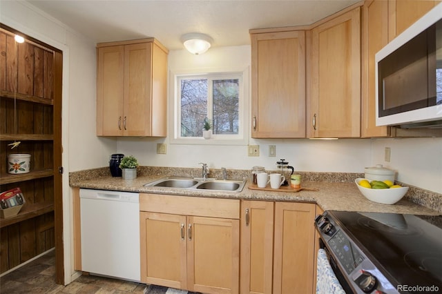 kitchen with a sink, white appliances, light brown cabinetry, and light countertops