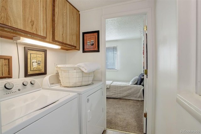 washroom with washer and dryer, carpet, cabinet space, and a textured ceiling