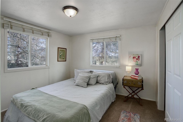 bedroom featuring a closet, carpet floors, and a textured ceiling