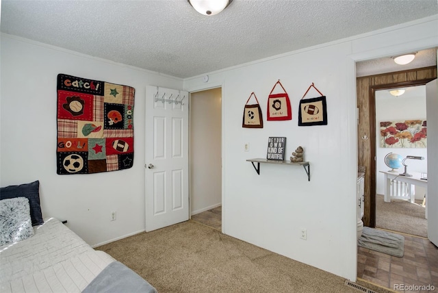 bedroom with a textured ceiling and carpet floors