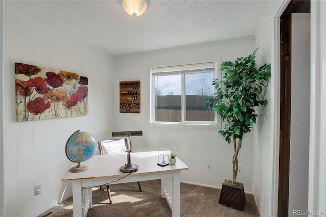 carpeted office with baseboards and a textured ceiling