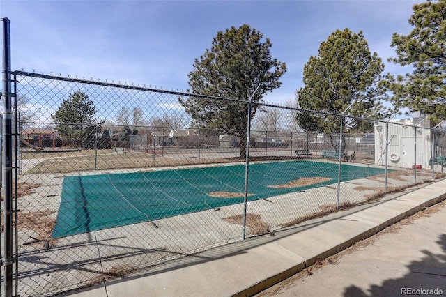 view of swimming pool with fence