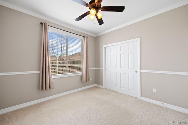 10127 Bluffmont Ln, Lone Tree, CO 80124 - unfurnished bedroom with light colored carpet, crown molding, a closet, baseboards, and a ceiling fan