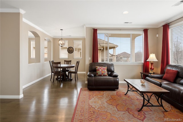 10127 Bluffmont Ln, Lone Tree, CO 80124 - living room with baseboards, arched walkways, a chandelier, wood finished floors, and ornamental molding