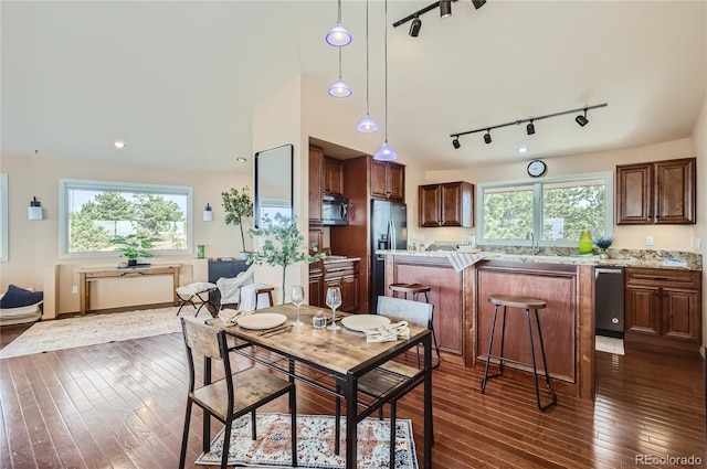 3001 Eagle Ridge Rd, Longmont, CO 80503 - dining space featuring rail lighting and dark wood-style flooring