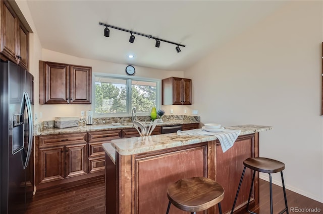 3001 Eagle Ridge Rd, Longmont, CO 80503 - kitchen with stainless steel appliances, track lighting, dark wood finished floors, and light stone counters