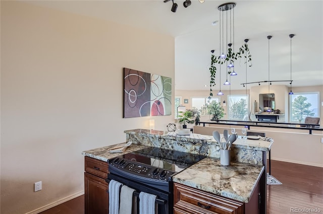 3001 Eagle Ridge Rd, Longmont, CO 80503 - kitchen featuring black / electric stove, healthy amount of natural light, dark wood-style flooring, and baseboards