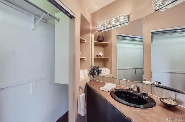 3001 Eagle Ridge Rd, Longmont, CO 80503 - bathroom with a walk in closet and vanity