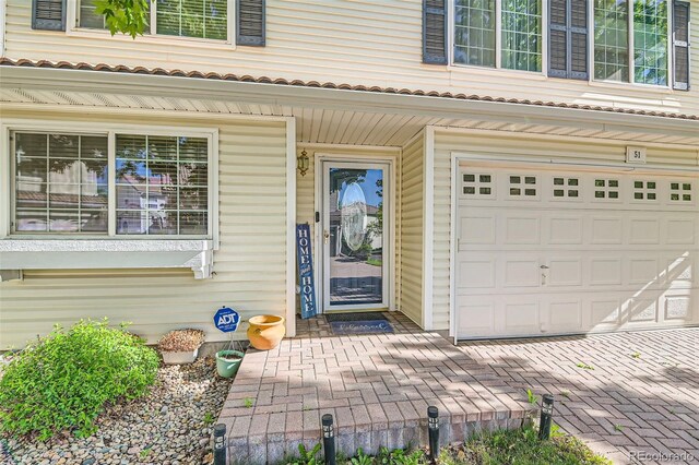 20000 Mitchell Pl Unit 51, Denver, CO 80249 - doorway to property with a garage and covered porch