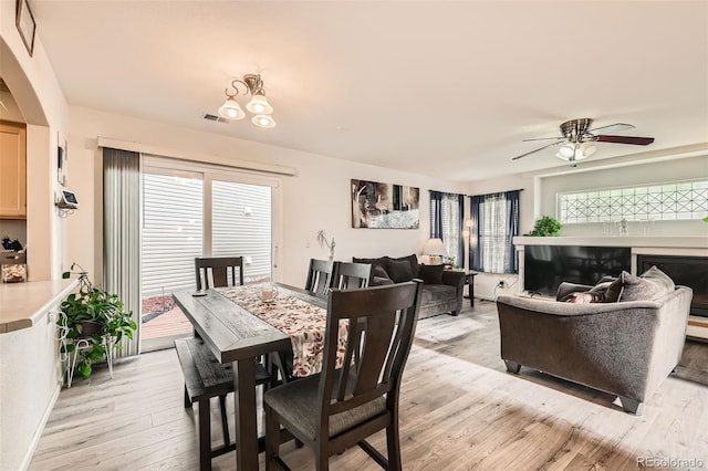 20000 Mitchell Pl Unit 51, Denver, CO 80249 - dining room featuring light wood-style floors, ceiling fan, and arched walkways