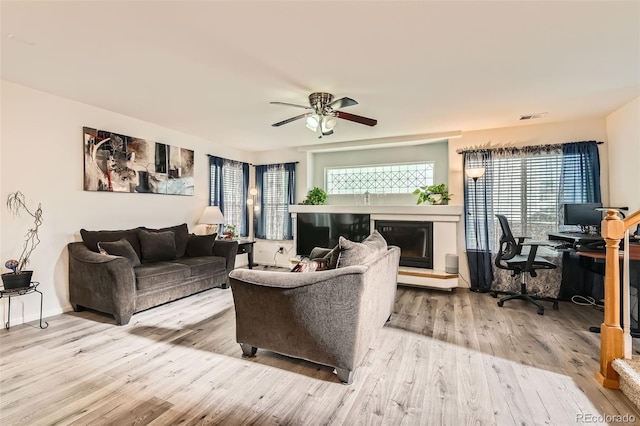 20000 Mitchell Pl Unit 51, Denver, CO 80249 - living area with wood finished floors, ceiling fan, an office area, and a glass covered fireplace