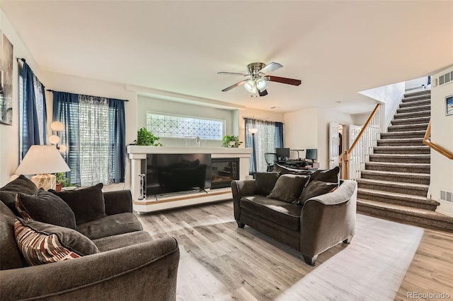 20000 Mitchell Pl Unit 51, Denver, CO 80249 - living area with stairs, wood finished floors, ceiling fan, and a fireplace