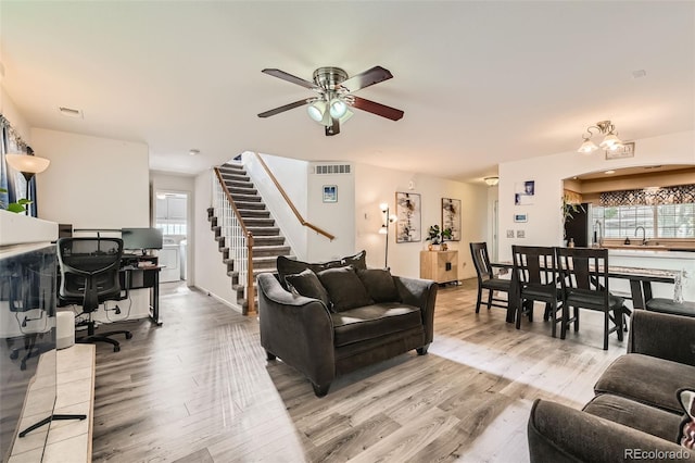 20000 Mitchell Pl Unit 51, Denver, CO 80249 - living area featuring light wood finished floors, a ceiling fan, stairway, and a desk