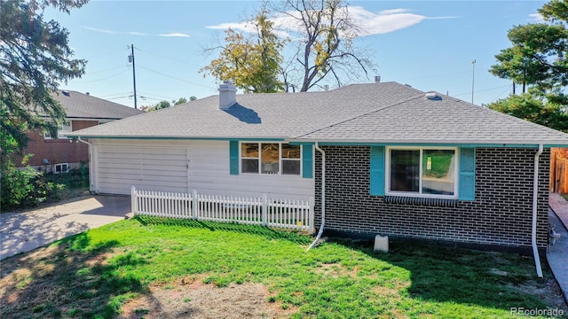 rear view of property featuring a lawn