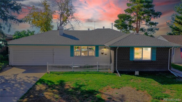 3067 S Holly Pl, Denver, CO 80222 - view of front of house featuring a garage, driveway, a chimney, and a shingled roof