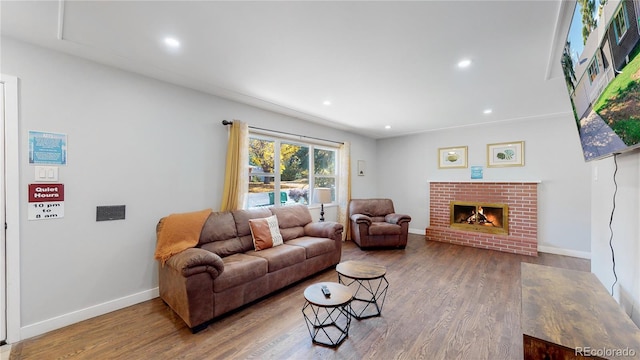 3067 S Holly Pl, Denver, CO 80222 - living room with wood finished floors, baseboards, a fireplace, and recessed lighting