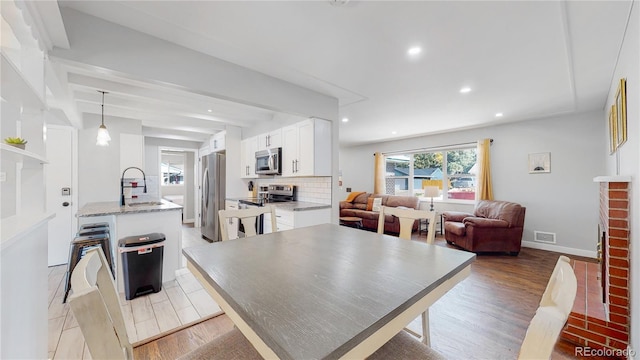 3067 S Holly Pl, Denver, CO 80222 - dining space with light wood-style floors, recessed lighting, and baseboards
