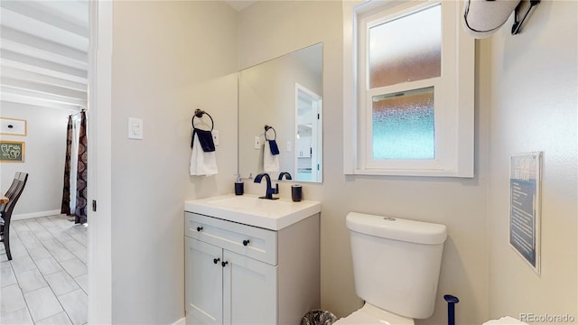 3067 S Holly Pl, Denver, CO 80222 - bathroom featuring toilet, vanity, and baseboards