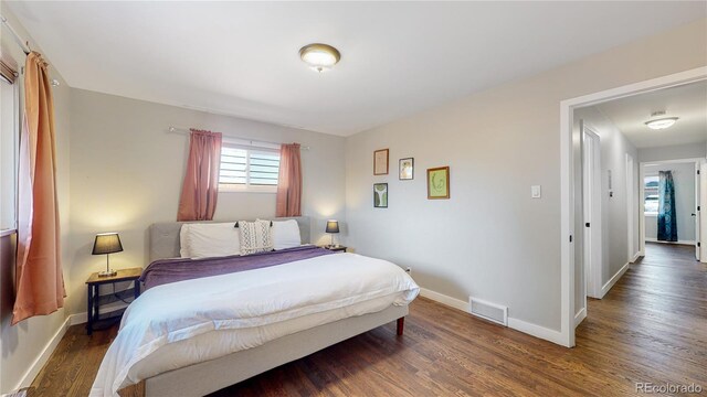 3067 S Holly Pl, Denver, CO 80222 - bedroom featuring wood finished floors and baseboards