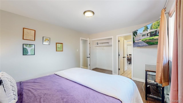 3067 S Holly Pl, Denver, CO 80222 - bedroom with wood finished floors and a closet