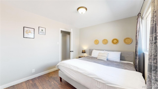 3067 S Holly Pl, Denver, CO 80222 - bedroom with dark wood-type flooring and baseboards