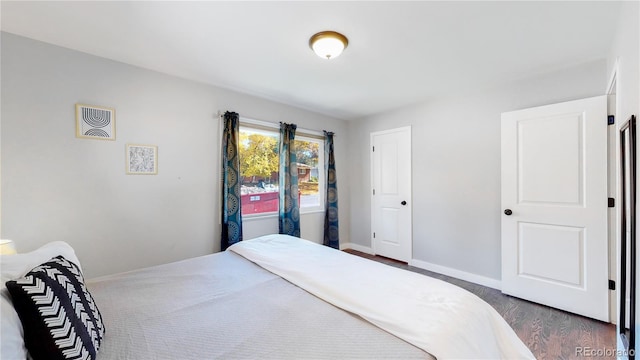 3067 S Holly Pl, Denver, CO 80222 - bedroom with dark wood-style flooring and baseboards