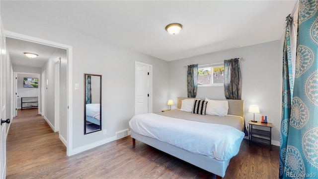 3067 S Holly Pl, Denver, CO 80222 - bedroom featuring wood finished floors and baseboards