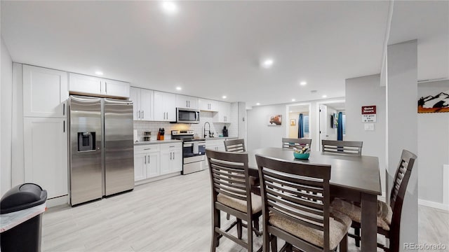 3067 S Holly Pl, Denver, CO 80222 - dining room with recessed lighting and light wood-type flooring