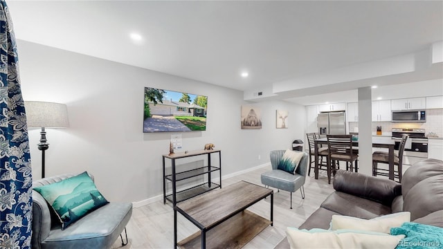 3067 S Holly Pl, Denver, CO 80222 - living room featuring recessed lighting, light wood finished floors, and baseboards
