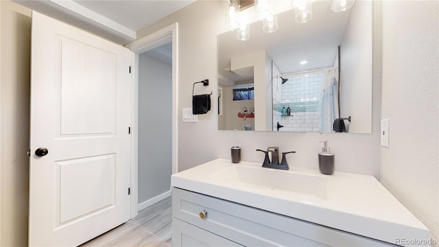 3067 S Holly Pl, Denver, CO 80222 - full bath with vanity, a shower with shower curtain, wood finished floors, and baseboards