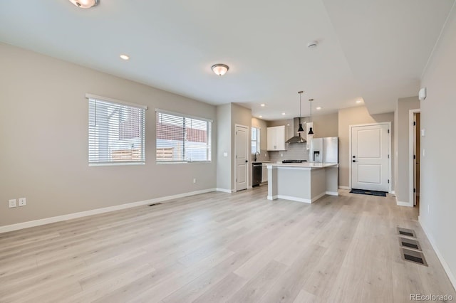6926 Kendrick Ln, Arvada, CO 80007 - unfurnished living room with recessed lighting, baseboards, and light wood finished floors