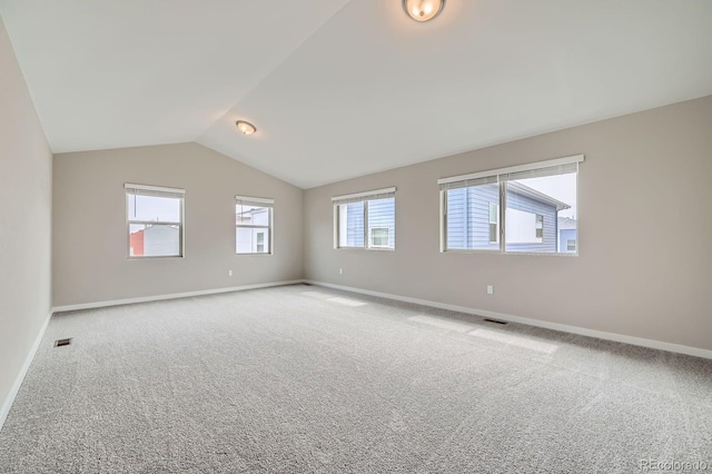 6926 Kendrick Ln, Arvada, CO 80007 - additional living space featuring visible vents, baseboards, vaulted ceiling, and carpet