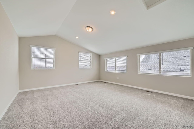6926 Kendrick Ln, Arvada, CO 80007 - empty room featuring visible vents, carpet floors, baseboards, lofted ceiling, and recessed lighting