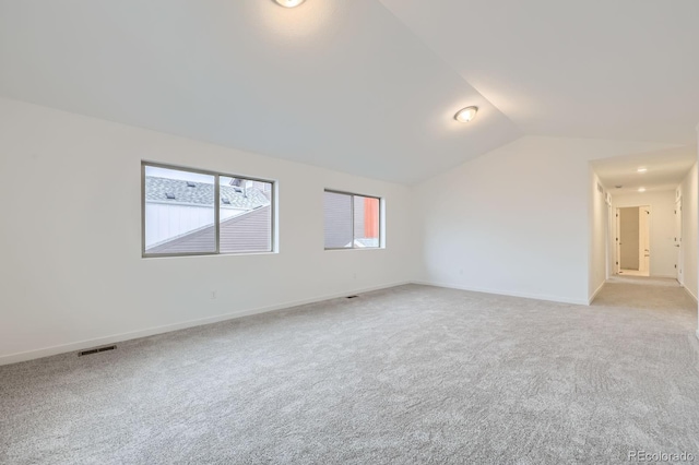 6926 Kendrick Ln, Arvada, CO 80007 - spare room featuring lofted ceiling and light carpet