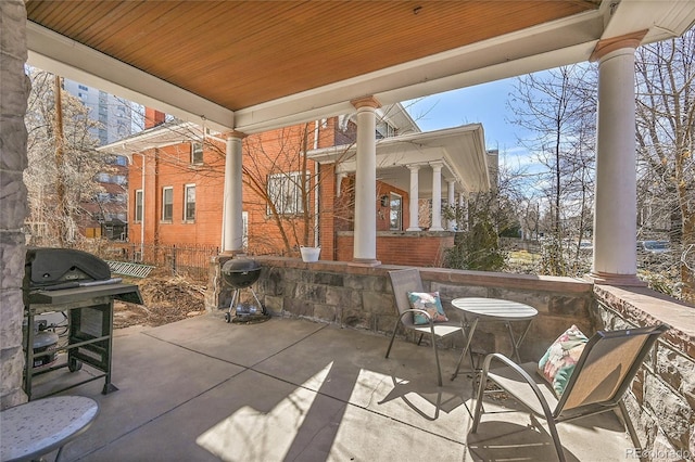 view of patio with grilling area and fence